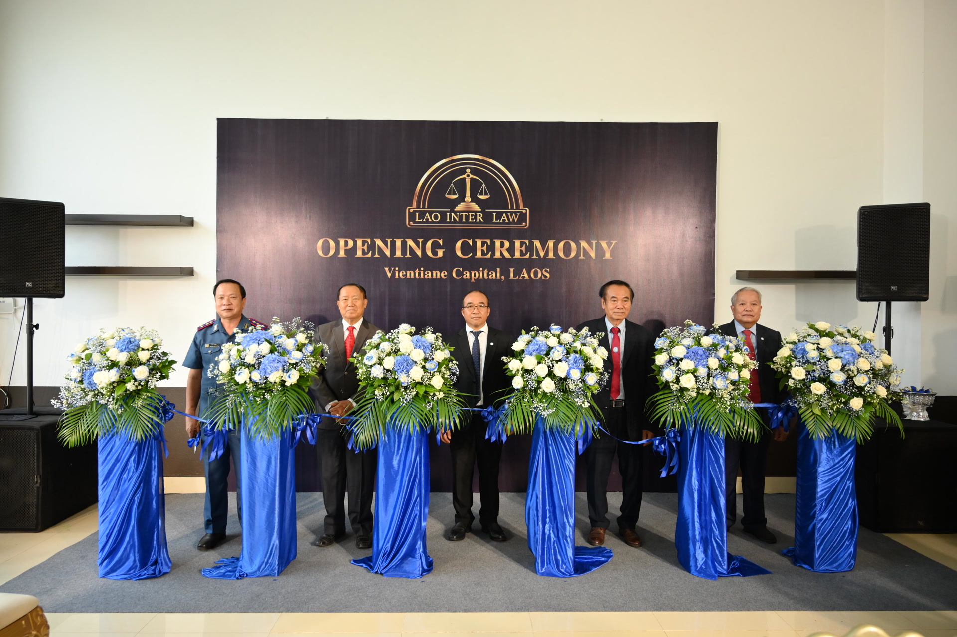 Officials and the firm's principals cutting the ribbon at the LAO INTER LAW opening ceremony in Vientiane.